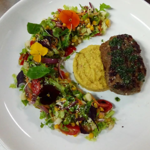 Beef fillet with avocado and tabasco sauce, served with salad..